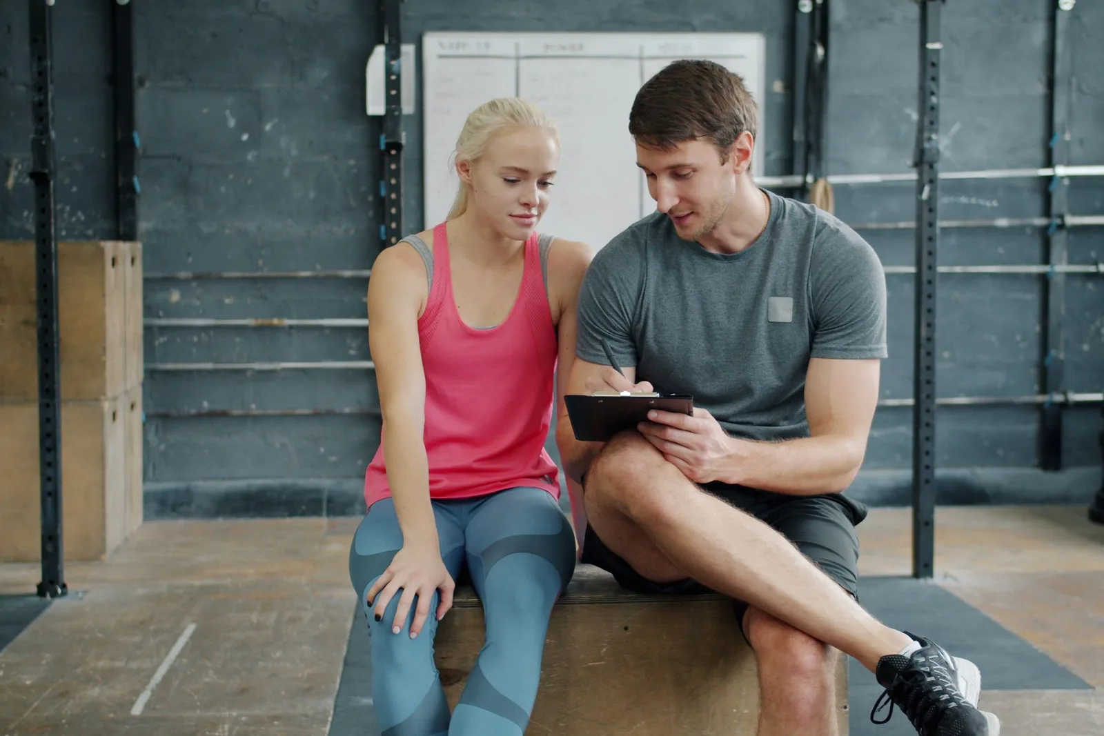 Trainer und Athletin besprechen gemeinsam einen Trainingsplan